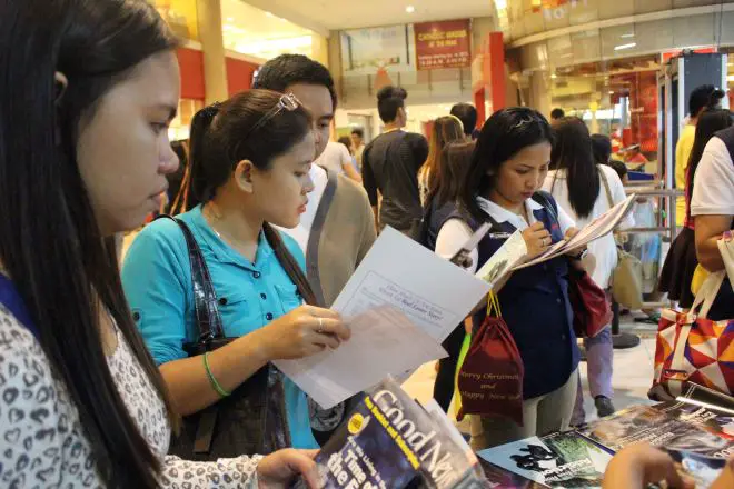 People Reading The Good News Magazine
