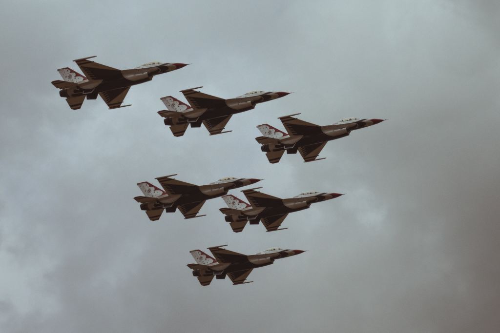 Jet fighters flying in battle formation.