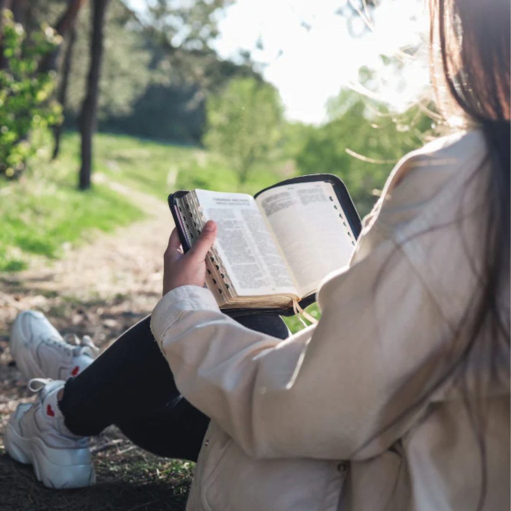 bible reading woman outdoor with trees and plants