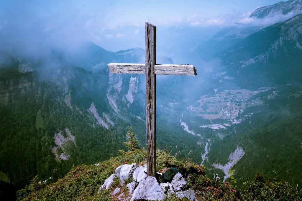 wooden cross overlooking over a mountain
