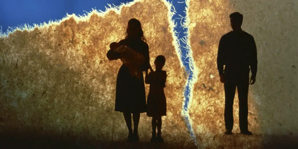 a family broken separated the man is left alone while the mother and children are together