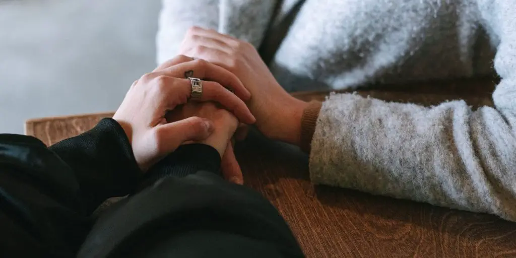 two persons forgiving each other.