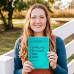 Kate Onyia holding her book Trudging Through Your Faith